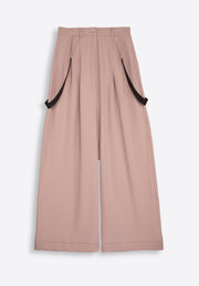 Rose wide-leg silk trousers on plain background – East Vibe